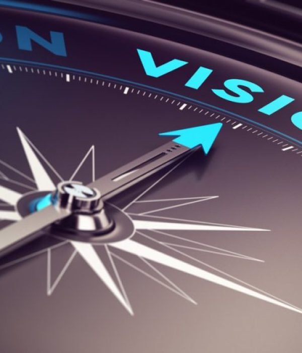 Compass with needle pointing the word vision with blur effect plus blue and black tones. Conceptual image for immustration of company or business anticipation or strategy